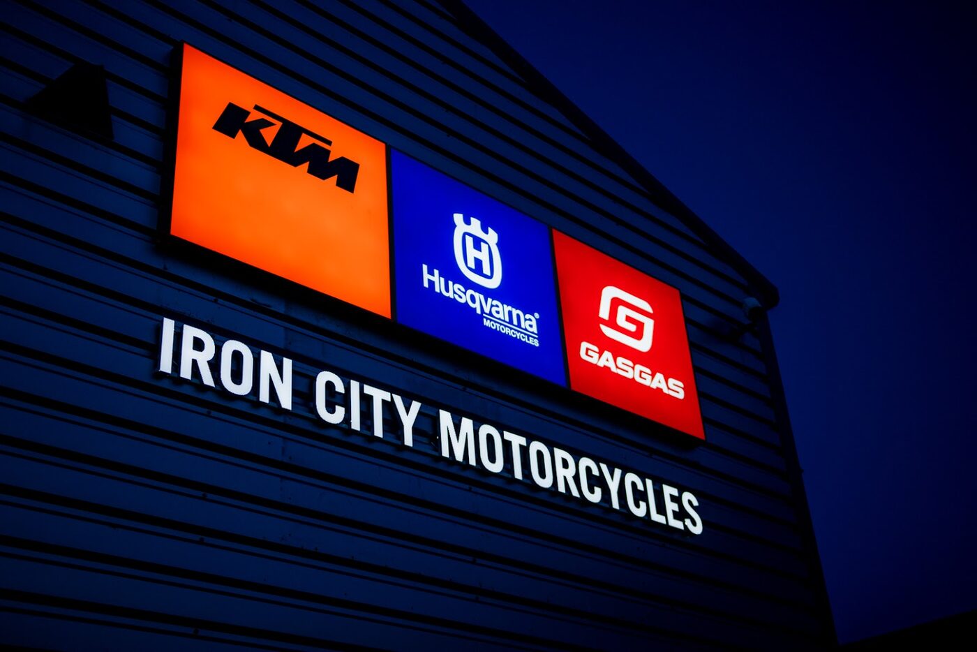 KTM, Husqvarna and GASGAS signage above the Iron City Motorcycles name
